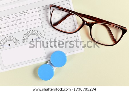 Medical eyeglass prescription with parameters, glases and contact lens container on yellow background