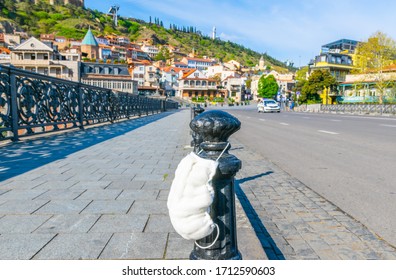 Medical face mask with police car patrol in Tbilisi old town  with no cars around. Quarantine and automobile  restriction in capital cities. Georgia. 20.04.2020