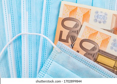 Medical Face Masks And Money. Surgical Face Mask.
COVID-19 Has Caused A Shortage Of Face Masks.
Euro Banknotes And Medical Face Masks.