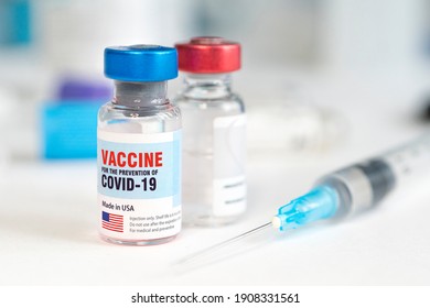 Medical Glass Vial And Plastic Syringe For Injection On White Table With Blue Gradient Background. Concept Of Vaccination In The United States Of America. Copy Space.