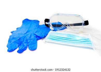 Medical gloves, surgical mask and goggles on white background. - Shutterstock ID 1912324132