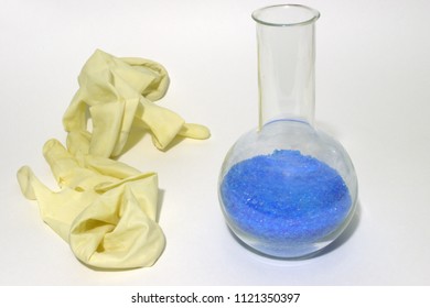 Medical Gloves, Worn And Crumpled. Florence Flask Of Bright Cupric Sulfate