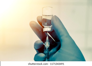 Medical hand glove blue molding vial vaccine hypodermic needle syringe injection treatment.Lab since test immunization and vaccination concept.drug insulin care prevention  diabetes disease hospital.