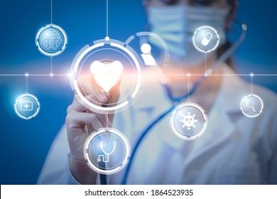 Medical healthcare Asian female doctor using tablet technology futuristic holographic wearing surgical protective face mask, information diagnosing patient health, stethoscope blue isolated background - Shutterstock ID 1864523935