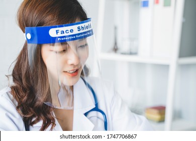 Medical Healthcare Beautiful Asian Doctor Wearing Face Shield Mask Protection From Infectious Disease Virus Bacteria Germs Coronavirus Covid-19, Safety Protection Working In Hospital Modern Office 