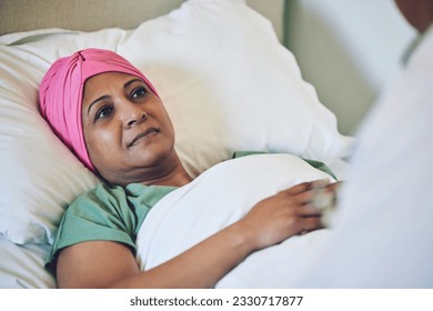 Medical, healthcare and cancer with muslim woman in bed at hospital for treatment or recovery. Islam, medicine or sad person in hospice with a sick or tired mature patient in clinic for chemotherapy - Powered by Shutterstock