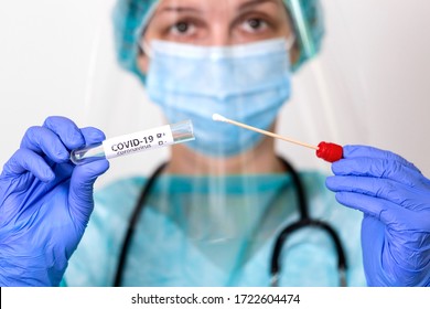 Medical healthcare holding COVID-19 , Coronavirus swab collection kit, wearing PPE protective suit mask gloves, test tube for taking OP NP patient specimen sample,PCR DNA testing protocol process