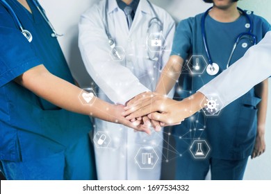 Medical And Healthcare Nurses And Doctors Working To Together Fighting Pandemic Of Corona Virus Disease, Standing Around With Hands On Top Each Other Forming Strong Bond, Motivation And Coordination  