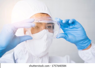 Medical healthcare scientist doctor wearing goggles blue latex gloves lab suit protective overall protection from bacterial infection virus safety clean sanitize, hospital laboratory white background 