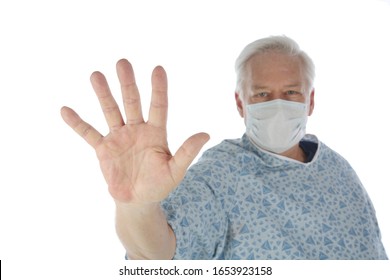 Medical Or Hospital Patient Wears A Paper Mask With His Hand As A STOP Sign. Stop Coronavirus2019 Or Stop Cancer Or Stop Sickness. The Possibilities Are Endless. Room For Text. Clipping Path. 