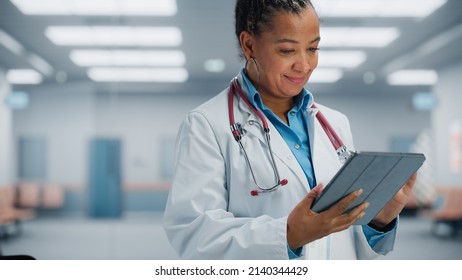 Medical Hospital Portrait: Confident African American Female Medical Doctor Using Digital Tablet Computer. Health Care Black Physician In White Lab Coat Prescribes Medicine, Ready To Save Lives