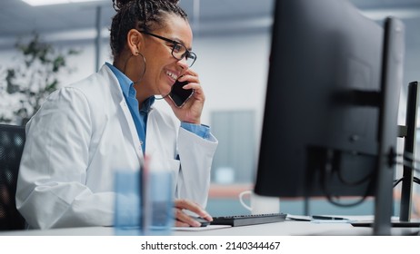 Medical Hospital Research Lab: Black Female Neurosurgeon Using Computer with Brain Scan MRI Images, Talking on the Phone with Sick Patient. Health Care Neurologist Finding Treatment. Energetic Arc
