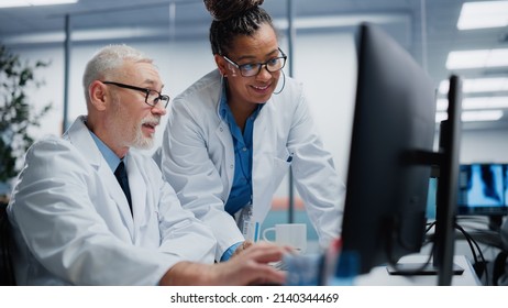 Medical Hospital: Two Doctors Talk and Use Computer, Diagnose and Tests Information, Finding Cure and Solution. Health Care Clinic Research with Team of Diverse Contemporary Professionals Working - Powered by Shutterstock