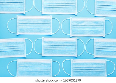 Medical hygienic mask, Face protective masks on blue background.Disposable surgical face mask protective against Coronovirus Covid-19,pollution, virus, flu.Healthcare medical surgical Flat lay pattern - Shutterstock ID 1689031279