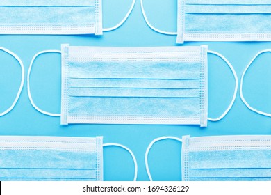 Medical Hygienic Mask, Face Protective Masks On Blue Background.Disposable Surgical Face Mask Protective Coronovirus Covid-19,pollution, Virus, Flu.Healthcare Medical Surgical Flat Lay Pattern