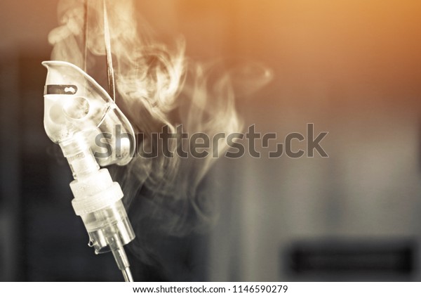 Medical inhaler emergency equipment blue back smoke\
background, treatment illness asthma disease neutralizer oxygen\
spray inhaler therapy,drug allergic cough asthmatic attack\
Hospital.selective\
focus