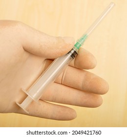 Medical injection plastic syringe and surgical glove can be used in the hospital, doctors and nurses, it is one of the equipment used in corona virus treatment to inject liquid medicine to patients - Shutterstock ID 2049421760