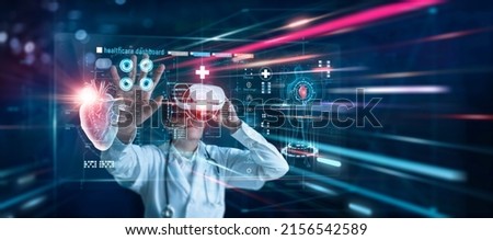 Medical innovation technology concept. Cardiologist doctor wearing virtual reality glasses. Checking heart disease and report testing result with simulator interface, Metaverse. Science and medicine