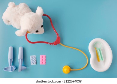 Medical Instruments For Children. First Aid Kit For Games In The Doctor's Office. Patient Toy. Blue Background.