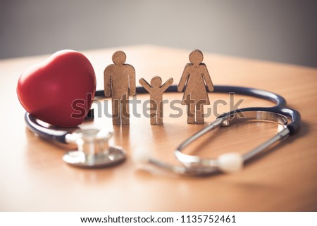 Medical Insurance Concept With Family  And Stethoscope On Wooden Desk