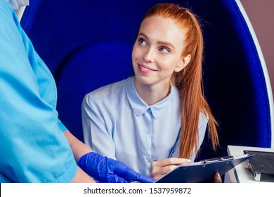 medical insurance concept.redhead ginger woman patient with a gynecologist during the consultation in the gynecological office,signing a document.sex education
