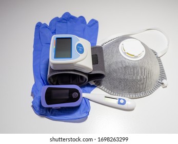 Medical Kit: Digital Body Thermometer, Pulse Oximeter, FFP2 Face Medical Mask And Arm Blood Pressure Monitor. Disposable Medical Gloves. Kit To Be Used To Check Values During Coronavirus Covid 19