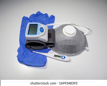 Medical Kit: Digital Body Thermometer For Body Temperature,  Face Medical Mask And Arm Blood Pressure Monitor. Disposable Medical Gloves. Kit To Be Used To Check Values During Coronavirus Covid 19