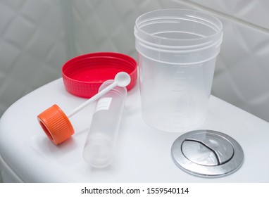 Medical kit for the sampling of feces and empty urine sample cup. Medical laboratory tests, concept.