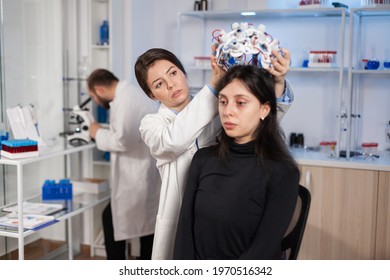 Medical Lab Technician Putting Eeg Headset Monitoring Brain Functions, Descovering Diagnosis Of Disease. Team Of Scientists Researchers Working Late Night In Neurology Clinic For Woman Health.