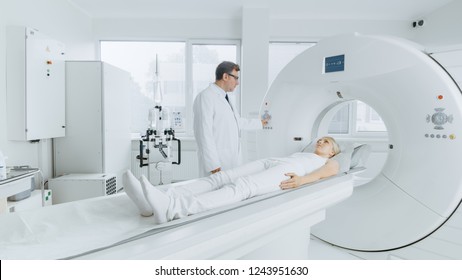 In Medical Laboratory Radiologist Controls MRI Or CT Or PET Scan With Female Patient Undergoing Procedure. Professional Doctor Conducts Emergency Checkup Procedure With Advanced Medical Technologies.