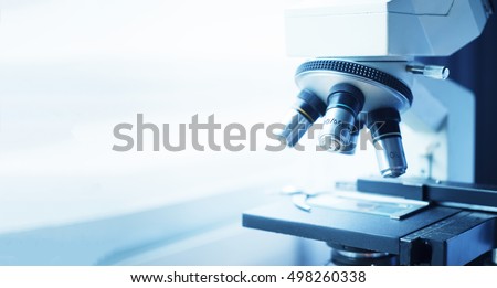 medical laboratory, scientist hands using microscope  for chemistry biology test samples,examining  liquid, equipment,Scientific and healthcare research background.vintage color
