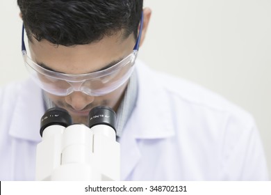 Medical Laboratory Scientist, Male Looking In A Microscope, Science Laboratory Concept