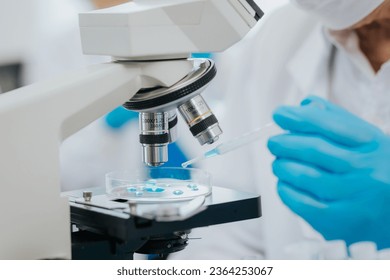 Medical laboratory: Two scientists using micropipettes for analysis Advanced Medical Science Laboratory biotechnology Development of microbiology hands close up - Powered by Shutterstock