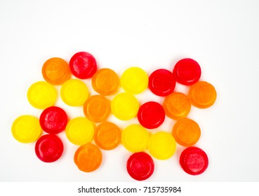 Medical Lozenges For Relief Cough, Sore Throat And Throat Irritation Isolated On White Background. Cough And Colds Drop. Colorful Cough Pastille. Red, Orange, And Yellow Round Candy Or Sweets.