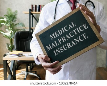 Medical Malpractice Insurance Or Professional Liability Concept. Doctor With Blackboard.