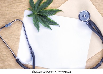 Medical marijuana background with blank paper, cannabis leaf and stethoscope