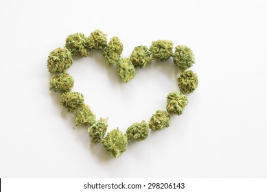 Medical Marijuana Buds Arranged Into A Heart Shape Against A White Background