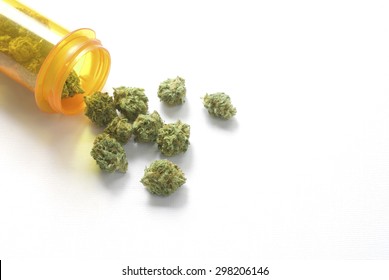 Medical Marijuana Buds Spilling Out Of A Prescription Pill Bottle On A White Background