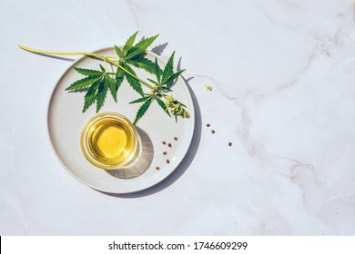 Medical marijuana cannabis cbd oil. CBD oil hemp products. Macro detail of dropper with CBD oil, cannabis live resin extraction on white background. Medical marijuana concept