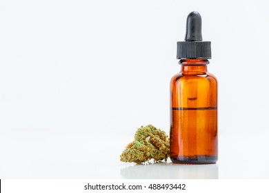 Medical Marijuana Cannabis Oil Extract In Bottle Isolated On White Background With Copy Space. Selective Focus.