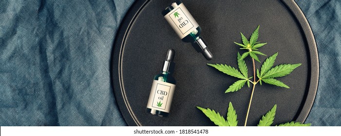 Medical Marijuana And Cannabis Products CBD Oil, Hemp Leaves On A Dark Background. Flat Lay, Copy Space Mockup