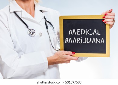 Medical Marijuana Chalkboard Sign Held By Female Doctor.