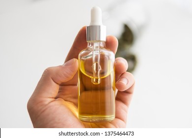 medical marijuana concept, close up, CBD cannabis OIL. hemp product, bottle of Cannabis oil in pipette in hand,