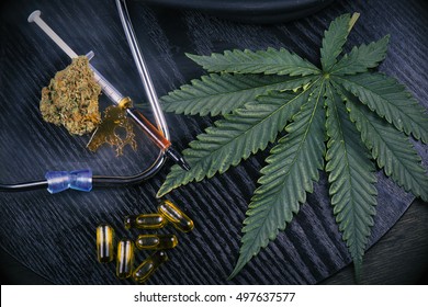 Medical Marijuana Products Including Cannabis Leaf, Dried Bud, Shatter Piece, Cbd Caps And Hash Oil Over Black Wood Background