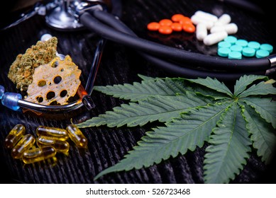 Medical Marijuana Products Including Cannabis Leaf, Dried Bud, Shatter Piece, Cbd Caps And Hash Oil Over Black Wood Background