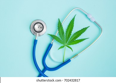 Medical marijuana and stethoscope. Green leaves of cannabis