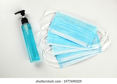 Medical mask and alcohol gel  for coronavirus preventive measure on white background .Healthcare and medical concept - Shutterstock ID 1977690329