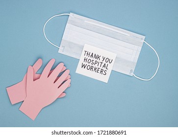 Medical Mask, Applauding Paper Hands And The Inscription Thank You Hospital Workers On A Blue Background. The Concept Of Gratitude To Medical Workers For Their Work