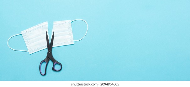 Medical Mask Cut Into 2 Parts And Scissors With Space For Text. View From Above.