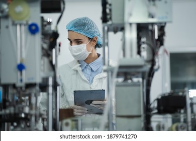 Medical mask factory, a team of medical professionals, a wide range of industries, programming and manipulation of high-tech facility robots Scientist Sterile clothing, lab work - Shutterstock ID 1879741270